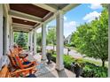 Charming front porch featuring comfortable seating, floral accents, and a view of the neighborhood street at 12999 Deerstyne Green St, Carmel, IN 46032