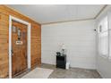 Cozy entryway with wood-paneled accent wall, front door, and neutral-toned flooring at 1331 S 9Th St, Noblesville, IN 46060