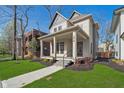Stylish two-story home featuring a covered porch and well-maintained landscaping, offering curb appeal at 1818 Central Ave, Indianapolis, IN 46202