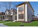 Contemporary two-story home with modern design, green lawn and mature trees at 1822 Central Ave, Indianapolis, IN 46202