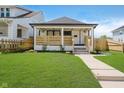 Charming home with a inviting front porch, and well-manicured lawn, perfect for relaxing outdoors at 2909 E Michigan St, Indianapolis, IN 46201