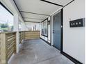 Inviting front porch featuring a modern railing, providing a welcoming entrance to this charming home at 2909 E Michigan St, Indianapolis, IN 46201