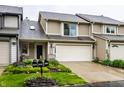 Charming townhouse with beautiful landscaping, two-car garage, and lovely curb appeal at 2949 River Bay N Dr, Indianapolis, IN 46240