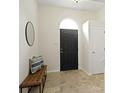 Well-lit foyer features a stylish bench, tiled floor and an arched front door at 3014 Saddlehorn Dr, Carmel, IN 46033