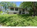 View of the white single Gathering home with lush green front yard and mature trees at 3668 Chatsbee Ct, Indianapolis, IN 46224
