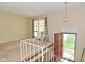 Bright living room featuring large windows, neutral walls and carpet at 3668 Chatsbee Ct, Indianapolis, IN 46224