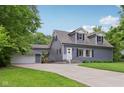 This two-story blue house features dormer windows and a detached garage at 3713 W 98Th St, Carmel, IN 46032