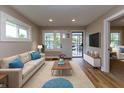 Bright living room featuring fresh paint, hardwood floors, and an abundance of natural light at 3822 Spann Ave, Indianapolis, IN 46203
