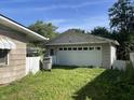 View of detached garage with white door, side access door, and white picket fence at 3908 Bertrand Rd, Indianapolis, IN 46222
