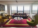 Bright living room featuring large windows, unique furniture, and a modern aesthetic at 4000 N Meridian St # Apt 11D, Indianapolis, IN 46208