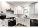 A beautifully updated kitchen featuring white cabinets, subway tile backsplash, and stainless steel appliances at 4926 Crittenden Ave, Indianapolis, IN 46205