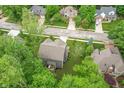 Aerial view of a two-story home with an attached garage and surrounding lush greenery in a neighborhood setting at 527 Macintosh Ln, Danville, IN 46122