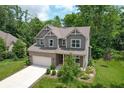 Charming two-story home with brick and gray siding, attached two-car garage and beautifully landscaped yard at 527 Macintosh Ln, Danville, IN 46122