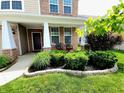 Inviting front porch with brick accents and manicured landscaping creates a welcoming entrance at 5379 Marigold Dr, Plainfield, IN 46168