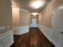 Long foyer with wood flooring, wainscoting, and ample lighting welcomes you inside this home at 5379 Marigold Dr, Plainfield, IN 46168