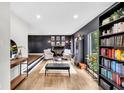 Living area with stylish decor, piano, hardwood floors, and natural light at 5506 Kessler Blvd N Dr, Indianapolis, IN 46228