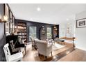 Comfortable living area featuring piano, hardwood floors, and neutral tones at 5506 Kessler Blvd N Dr, Indianapolis, IN 46228