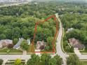 Aerial view of property highlighting lush landscaping and the home's location on a tree-lined street at 6363 Harmonridge Ct, Indianapolis, IN 46278