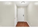 Hallway with access to unit entrance with wooden floors and painted white walls at 6518 Jade Stream Ct # 312, Indianapolis, IN 46237