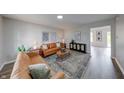 Comfortable living room featuring neutral walls, contemporary furnishings, hardwood floors, and recessed lighting at 705 Treyburn Lakes Way, Indianapolis, IN 46239