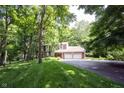 Brick home with a spacious lawn and mature trees, featuring a convenient two-car garage at 7115 Fremont Ct, Indianapolis, IN 46256