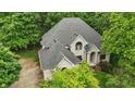 Sprawling home with a well-manicured lawn, mature trees, and a circular driveway, perfect for luxurious living at 7138 Nile Ridge Ct, Indianapolis, IN 46236