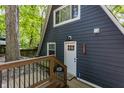 Close up of the home's entryway with dark siding and a white door at 7207 Grouper Dr, Nineveh, IN 46164