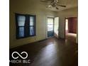 The living room features dark hardwood floors, vintage ceiling fan, and classic windows with dark trim at 721 Haugh St, Indianapolis, IN 46222