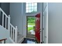 Inviting entryway with a peek outside, featuring stylish tile flooring and convenient coat closet at 7529 Oceanline Dr, Indianapolis, IN 46214