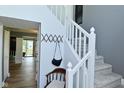 View of the carpeted staircase with white railing and chair rail and view of living space beyond at 7529 Oceanline Dr, Indianapolis, IN 46214