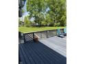 Spacious deck with lattice railing, offering a great view of the backyard and seating area at 8075 Cardinal E Cv, Indianapolis, IN 46256