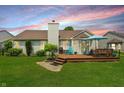 Beautiful backyard with a deck, lush green grass, and mature landscaping at 863 Lionshead Ln, Greenwood, IN 46143