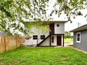 Exterior of this home showing a backyard entrance with stairs leading to a door at 9080 W Forest Dr, Elwood, IN 46036
