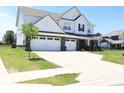 Beautifully landscaped home with a three-car garage, long driveway and sidewalk at 9640 Katana Cir, Fishers, IN 46040