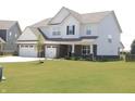 Attractive home with a three-car garage and freshly cut lawn on a sunny day at 9640 Katana Cir, Fishers, IN 46040