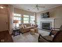 Bright living room with a fireplace and large windows, offering a cozy and inviting atmosphere for Gathering and guests at 9743 Herons Cv, Carmel, IN 46280