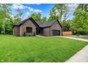 Charming brick home with a well-manicured lawn, offering comfort and curb appeal at 9811 Warren Pl, Indianapolis, IN 46229
