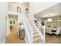 Welcoming foyer with staircase, hardwood floors, and natural light throughout at 10243 Brixton Ln, Fishers, IN 46037