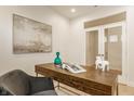 Stylish office with a rustic wooden desk, unique decor and a gray chair at 10922 Liberation Trce, Noblesville, IN 46060