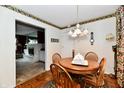 Cozy dining area with a round table, wooden chairs, and decorative wallpaper border, creating a warm and inviting space at 1102 Fox Hill Dr, Indianapolis, IN 46228