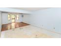 Spacious living room features wood and unfinished flooring and natural light at 1113 Delray Dr, Indianapolis, IN 46241