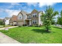 Beautiful two-story home with brick and vinyl siding, a well-maintained lawn, and an attached garage at 11849 Traymoore Dr, Fishers, IN 46038