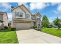 Two story home with a brick and vinyl exterior, two car garage, and a well manicured lawn at 11849 Traymoore Dr, Fishers, IN 46038