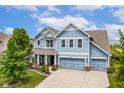 Beautiful two-story home featuring a covered porch and a spacious three-car garage at 12672 Amber Star Dr, Noblesville, IN 46060