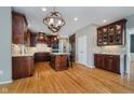 A kitchen with stainless steel appliances, a large island, and warm, wood cabinets at 13218 Beckwith Dr, Carmel, IN 46074