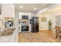 Modern kitchen with stainless steel appliances, granite countertops, and white cabinetry at 1398 Clinton St, Noblesville, IN 46060