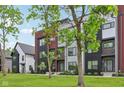 Modern townhouses with mixed siding and black accents on a lush green lawn with trees at 1816 Rosette Way, Indianapolis, IN 46202