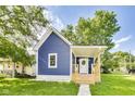 Inviting blue home with a quaint front porch and freshly manicured lawn at 1822 Howard St, Indianapolis, IN 46221