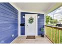 Charming front porch featuring a decorative wreath on the door and stylish outdoor lighting at 1822 Howard St, Indianapolis, IN 46221