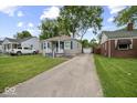 Features a detached garage and a long driveway at 1907 N Drexel Ave, Indianapolis, IN 46218